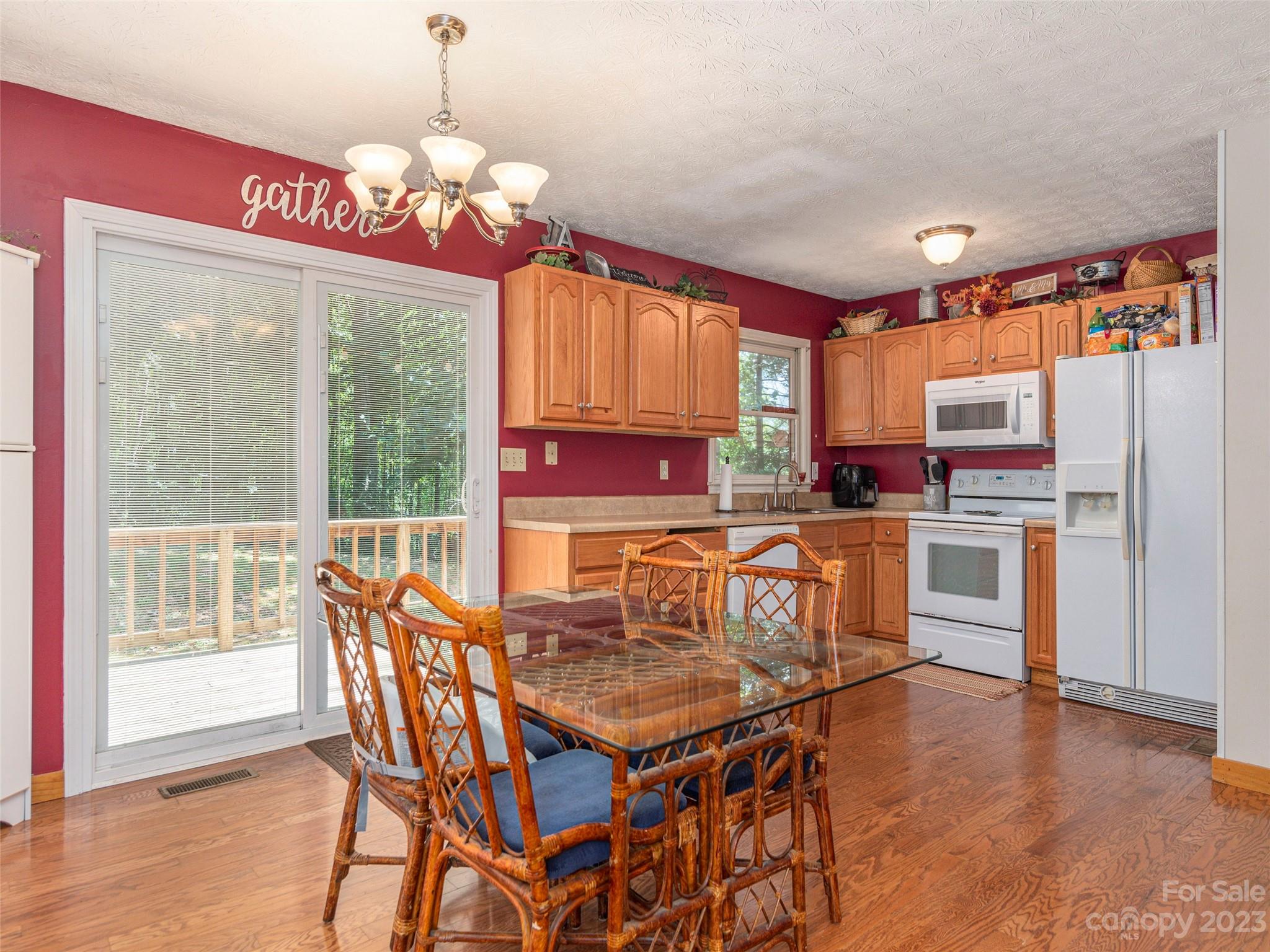 167 Paradise Circle Clyde, NC 28721 - Photo 7 of 18 a kitchen that has a table chairs and a refrigerator
