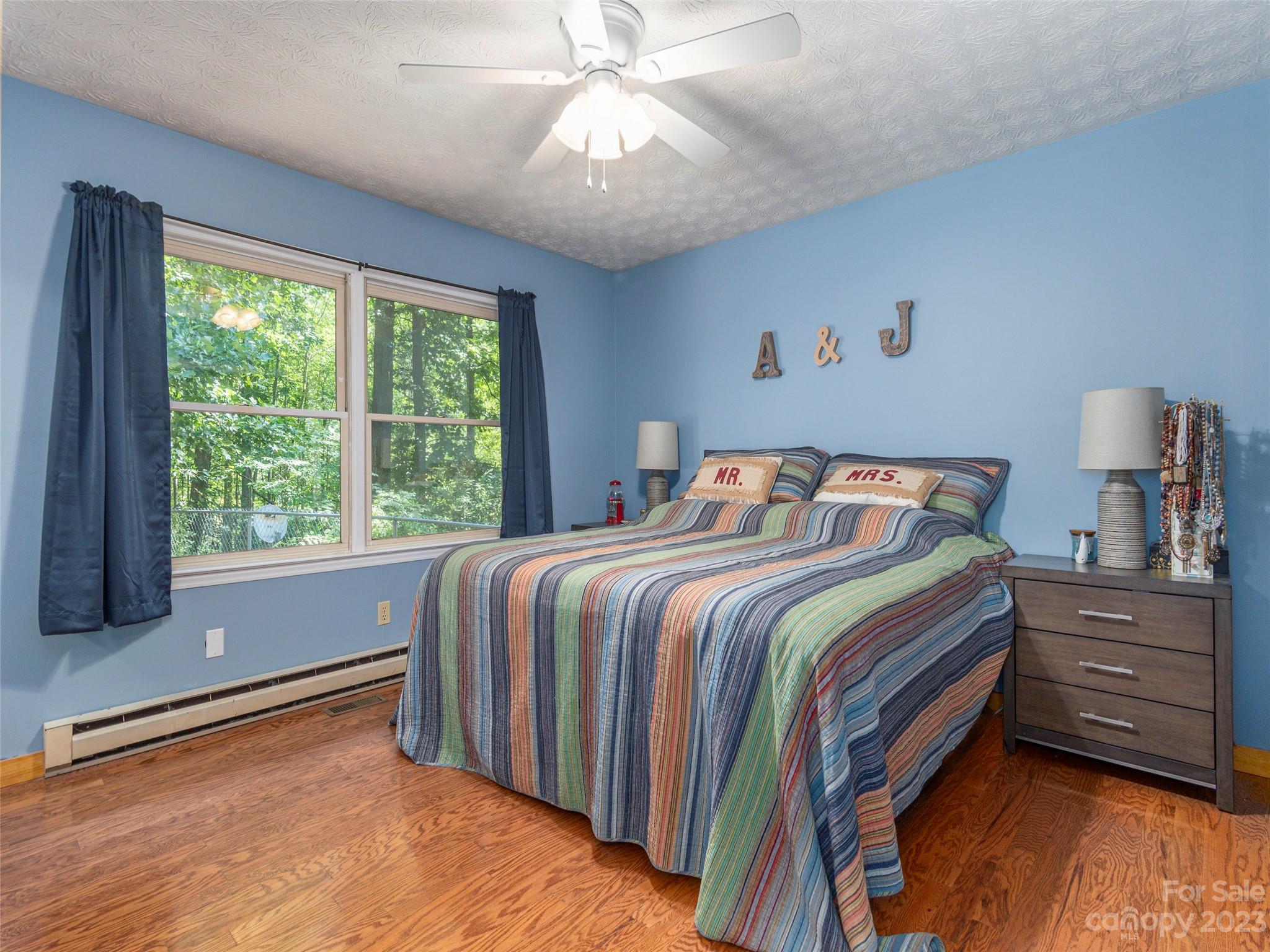 167 Paradise Circle Clyde, NC 28721 - Photo 9 of 18 a bedroom with a bed and a window