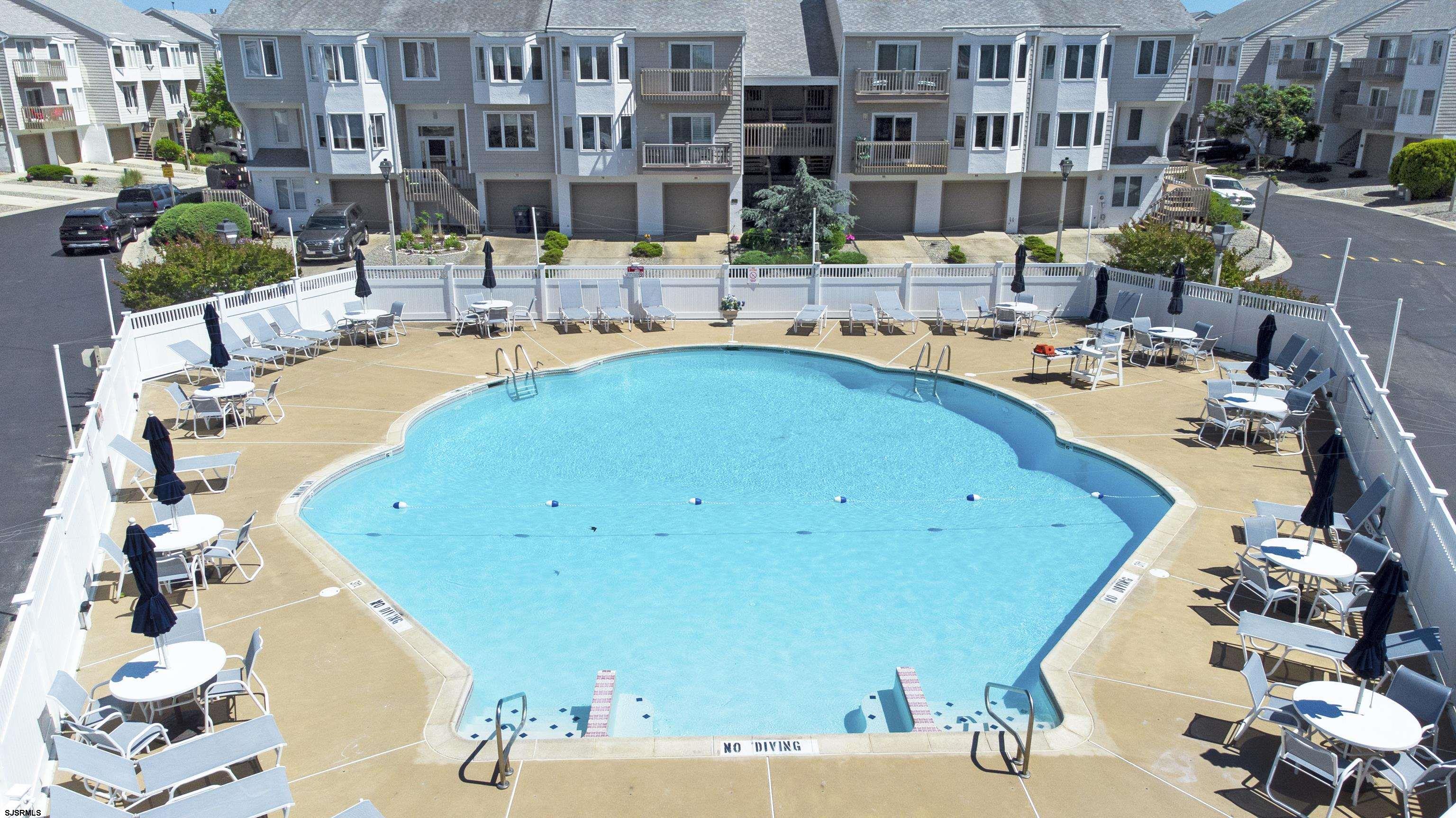 17 Coquille, Unit 17 Brigantine, NJ 08203 - Photo 7 of 33 a view of a swimming pool with outdoor seating