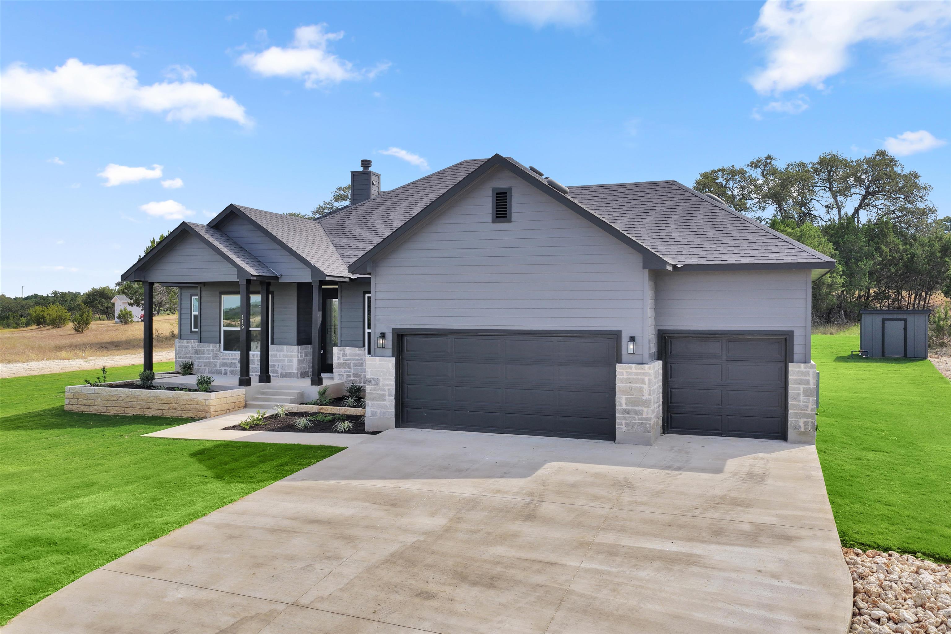 a front view of a house with a yard and garage