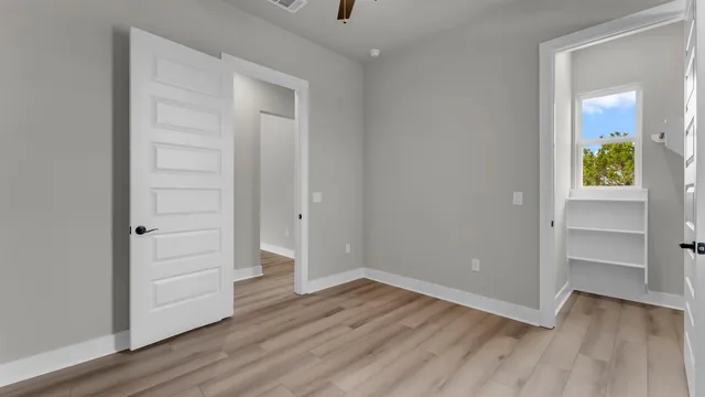 a bathroom with a granite countertop bathtub shower sink vanity and toilet
