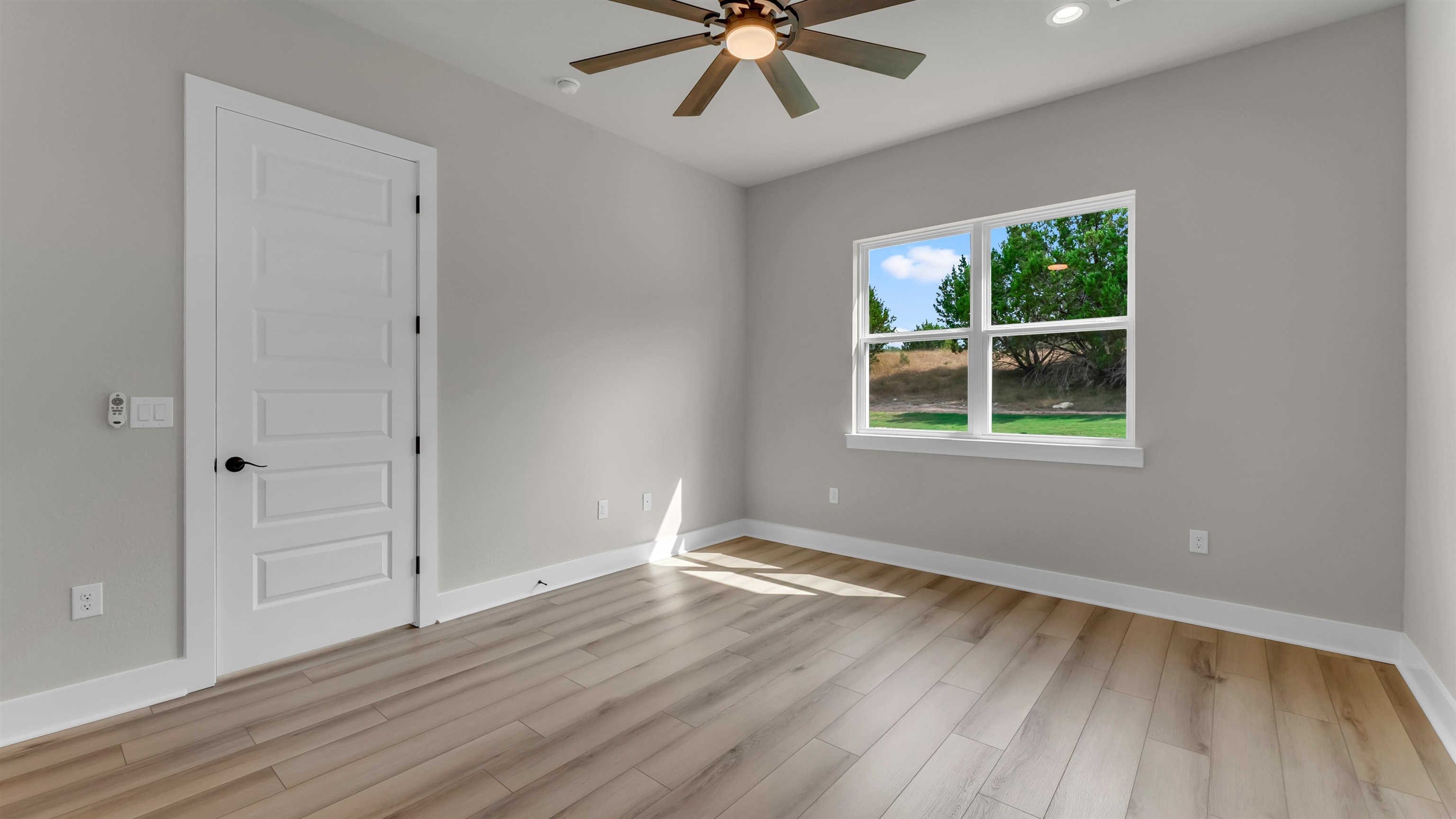 119 Garner Rnch Road Bertram, TX 78605 - Photo 21 of 25 wooden floor in an empty room with a window