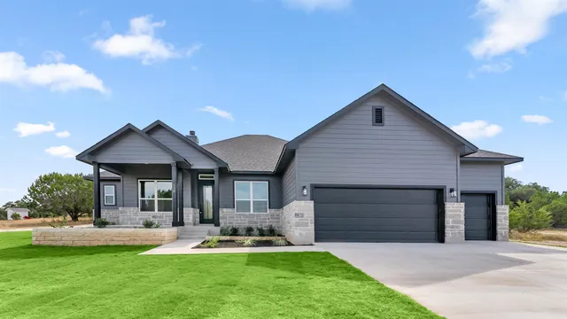 a front view of a house with a yard and porch