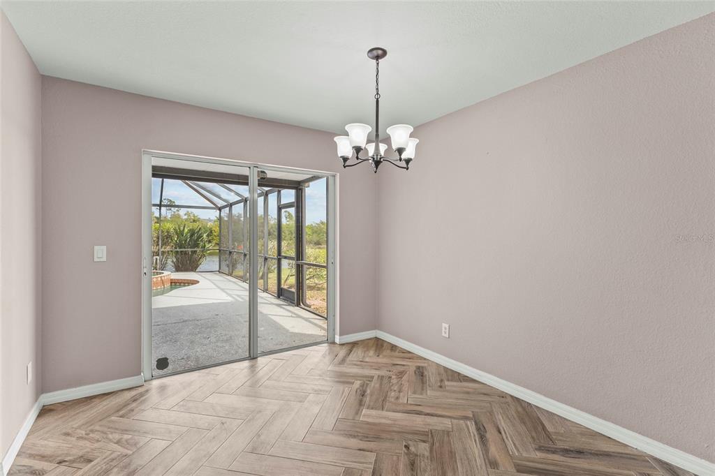11754 Tempest Harbor Loop Venice, FL 34292 - Photo 11 of 56 a view of a livingroom with wooden floor and a chandelier