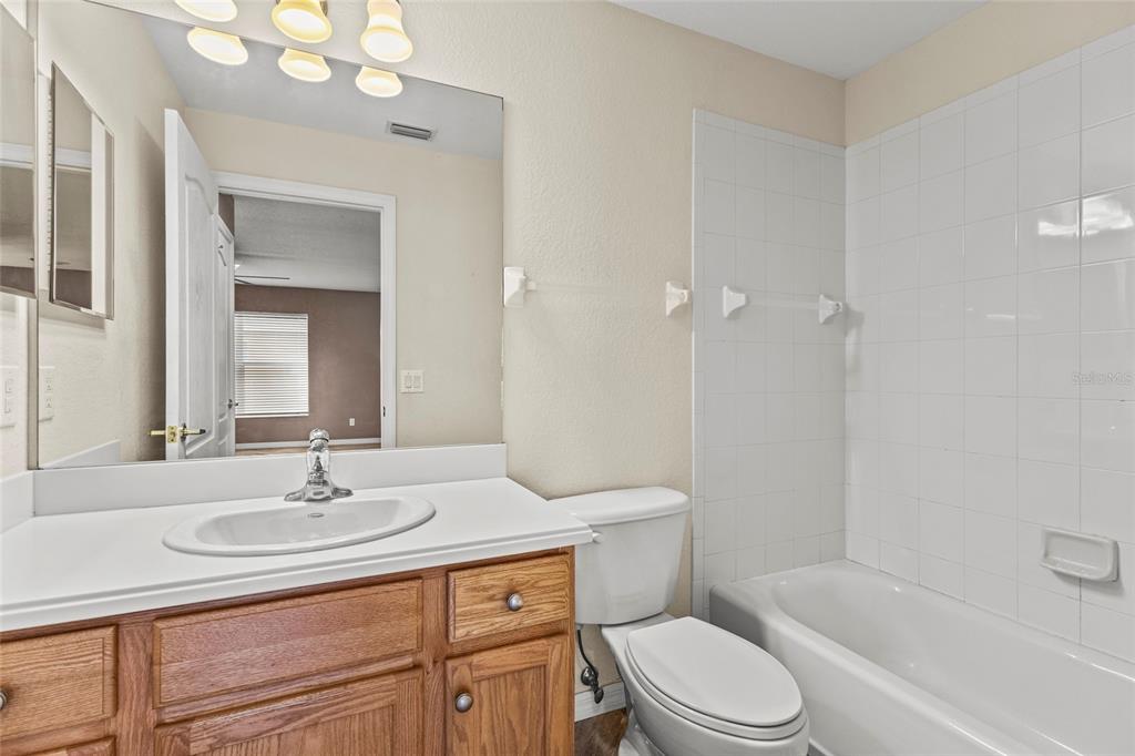 11754 Tempest Harbor Loop Venice, FL 34292 - Photo 21 of 56 a bathroom with a sink toilet a mirror and shower
