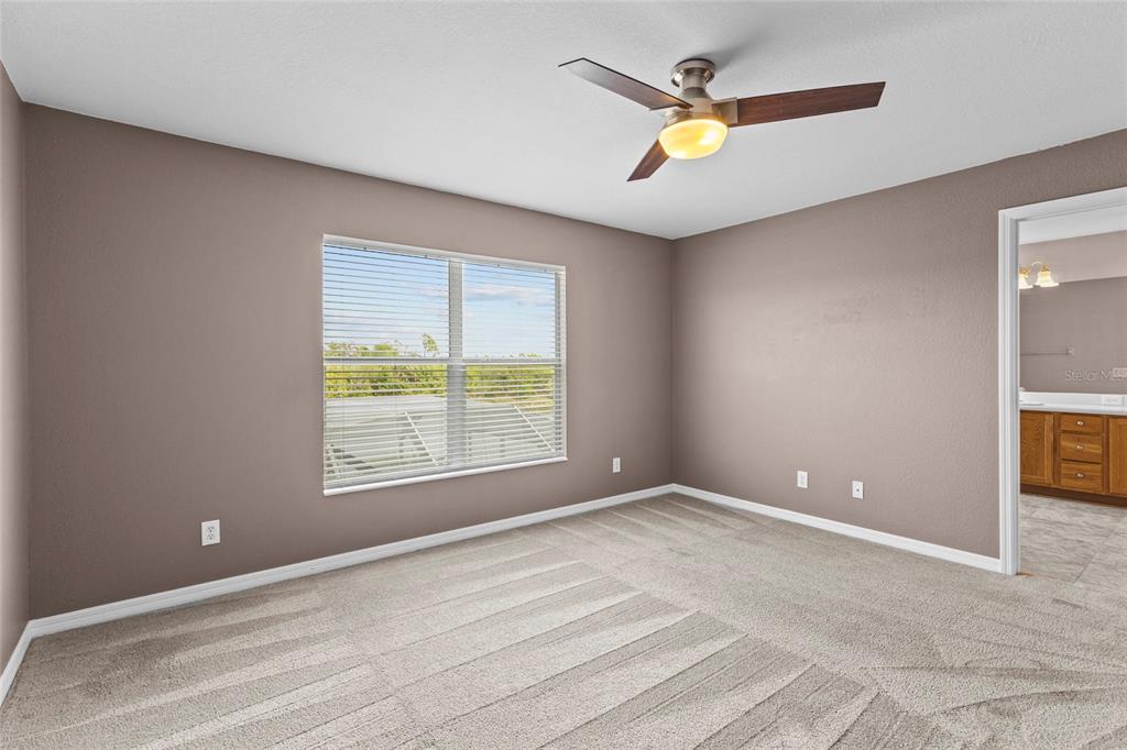 11754 Tempest Harbor Loop Venice, FL 34292 - Photo 23 of 56 a view of an empty room with window and chandelier fan