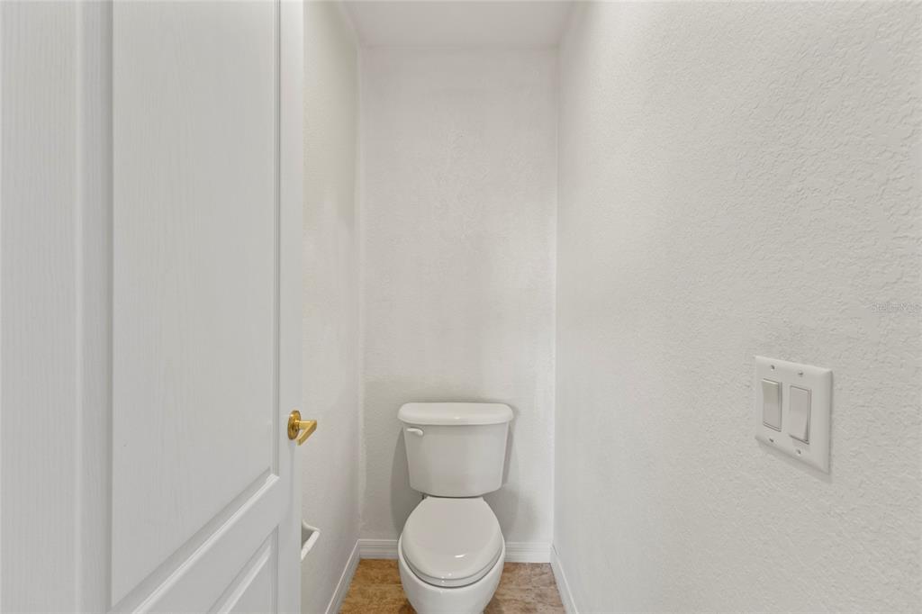 11754 Tempest Harbor Loop Venice, FL 34292 - Photo 27 of 56 a white toilet sitting next to a white wall