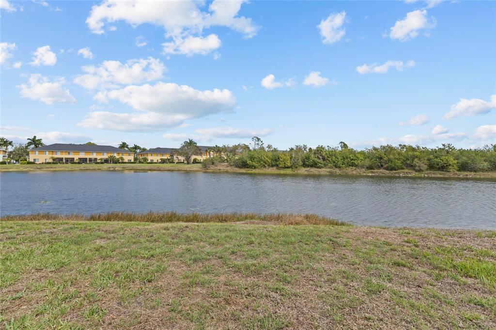 11754 Tempest Harbor Loop Venice, FL 34292 - Photo 31 of 56 a view of a lake with houses in the back