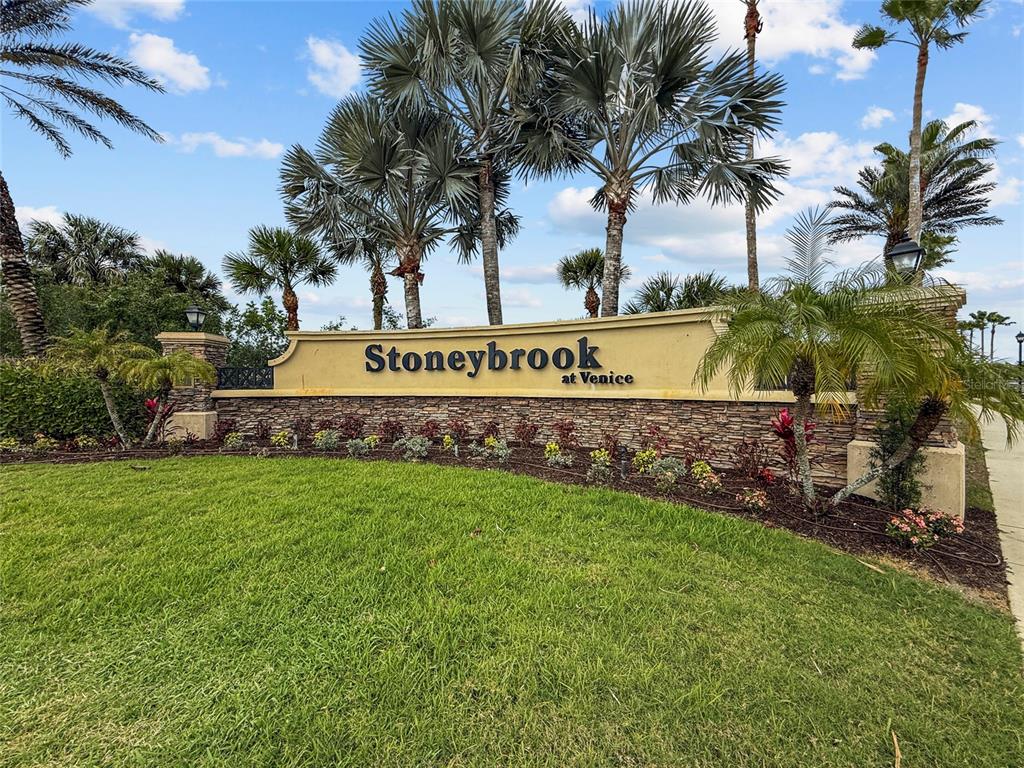 11754 Tempest Harbor Loop Venice, FL 34292 - Photo 33 of 56 a sign of golf club on a wall under a tree