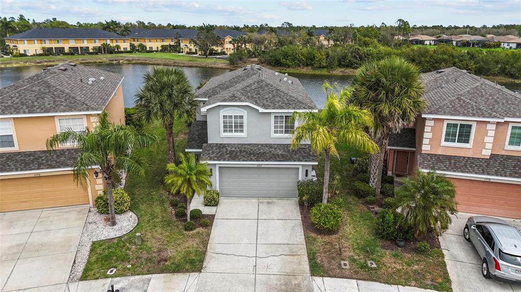 11754 Tempest Harbor Loop Venice, FL 34292 - Photo 40 of 56 an aerial view of a house with a yard and a large tree