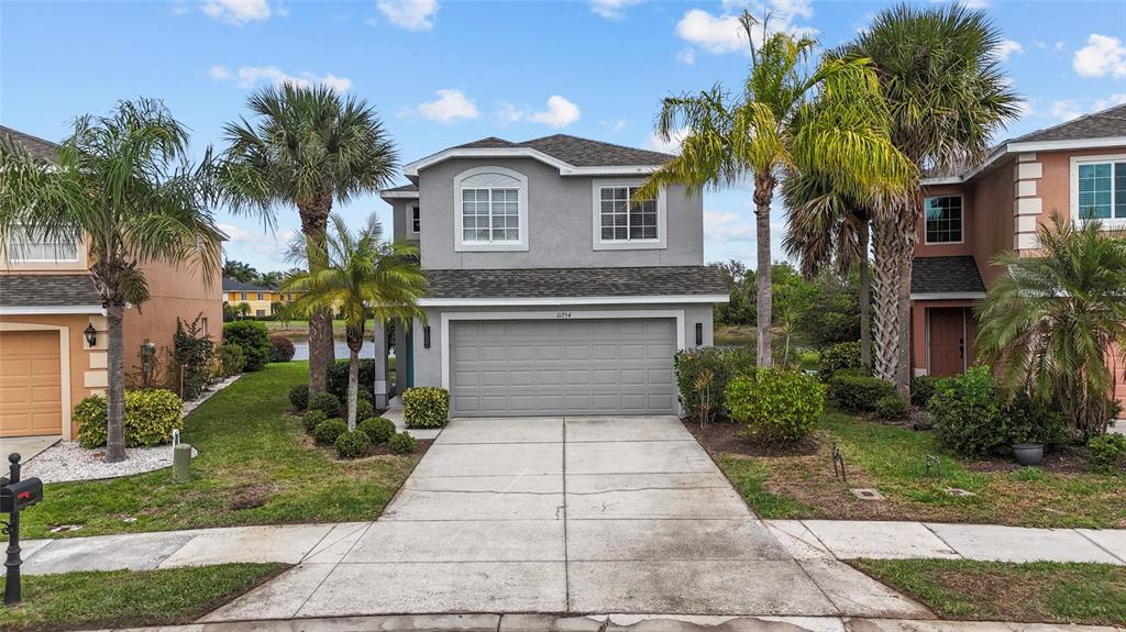 11754 Tempest Harbor Loop Venice, FL 34292 - Photo 46 of 56 a front view of a house with a garden