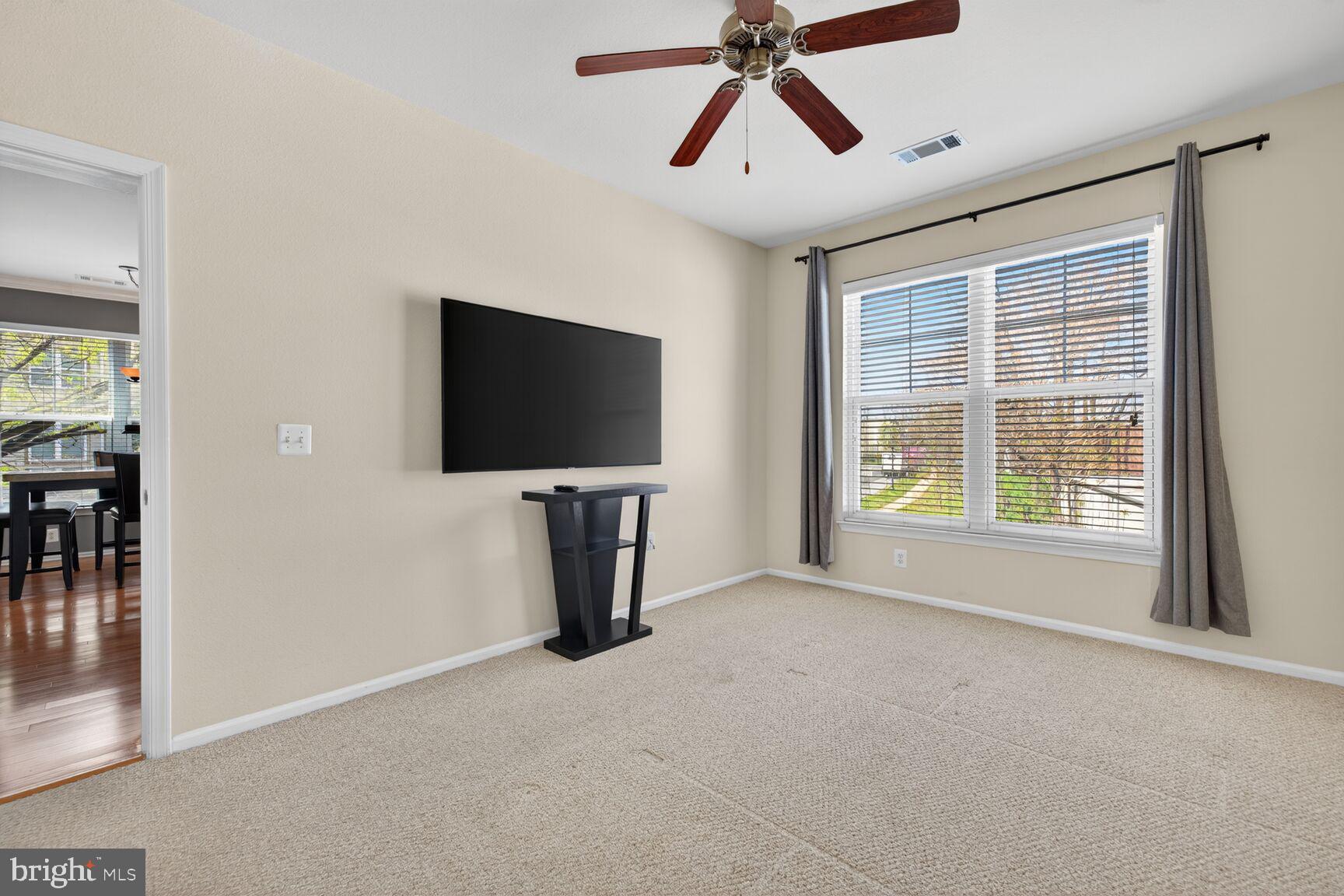11800 Old Georgetown Road, Unit 1541 North Bethesda, MD 20852 - Photo 14 of 34 a living room with a flat screen tv and a window
