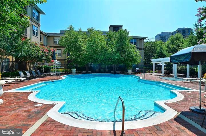 11800 Old Georgetown Road, Unit 1541 North Bethesda, MD 20852 - Photo 25 of 34 a view of a house with backyard swimming pool and sitting area