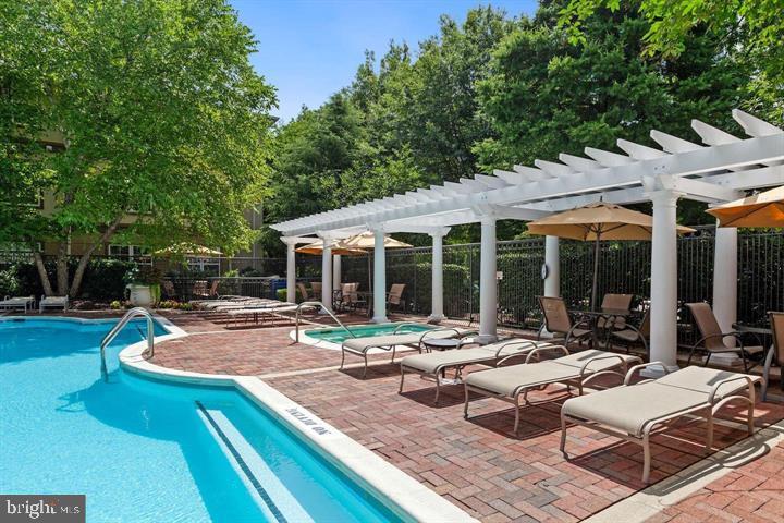 11800 Old Georgetown Road, Unit 1541 North Bethesda, MD 20852 - Photo 26 of 34 a view of a patio with couches and chairs under an umbrella