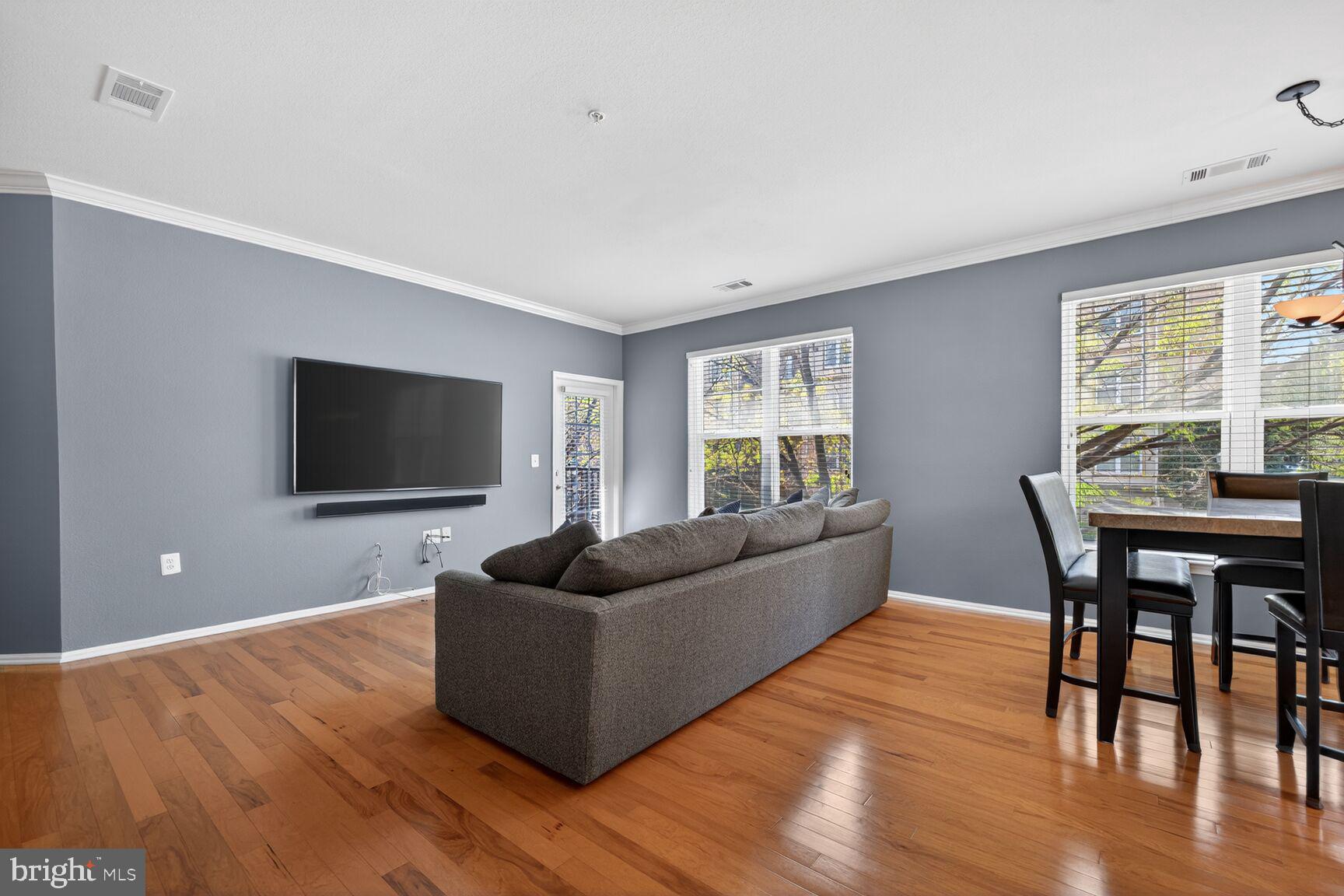 11800 Old Georgetown Road, Unit 1541 North Bethesda, MD 20852 - Photo 7 of 34 a living room with furniture wooden floor and a flat screen tv