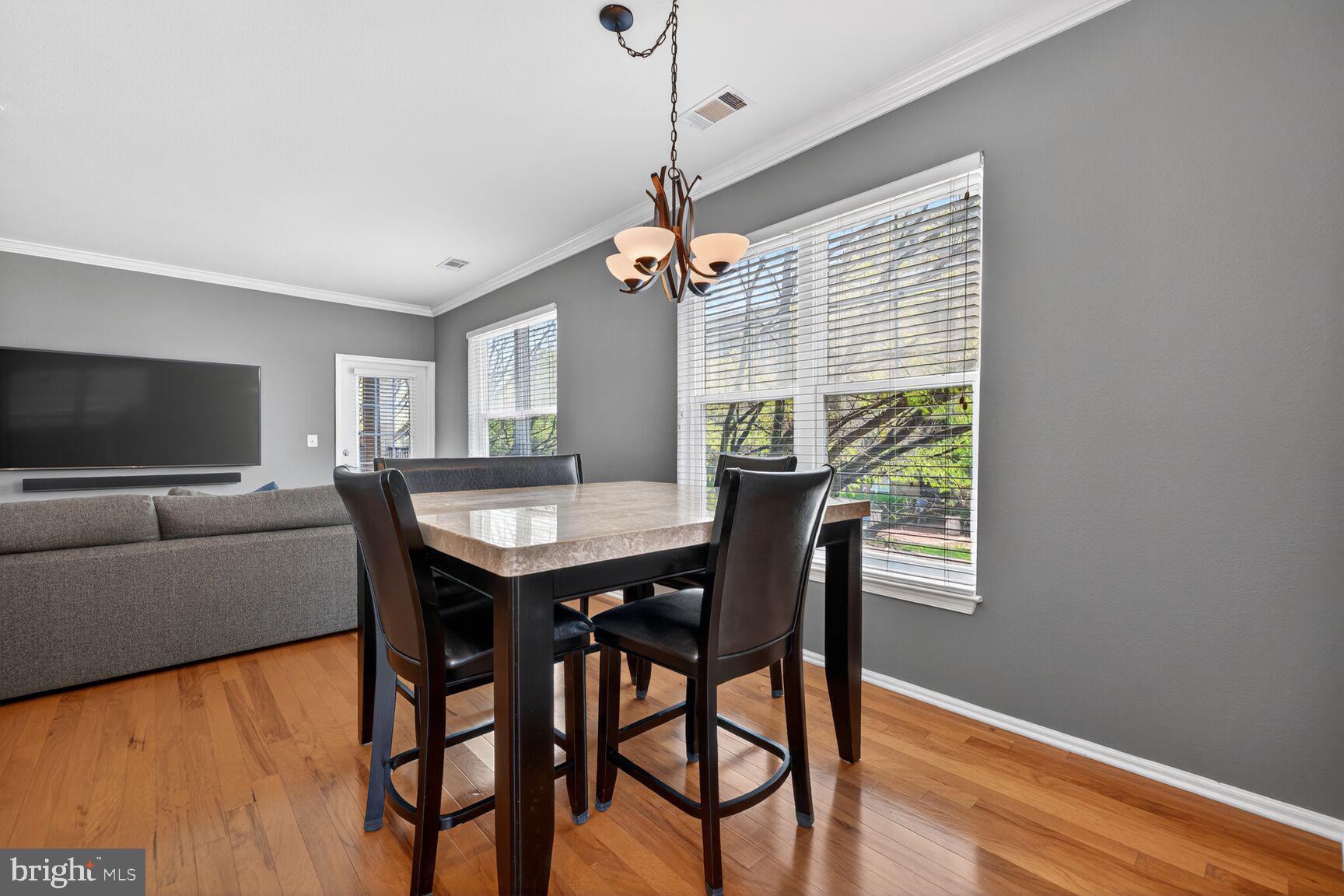 11800 Old Georgetown Road, Unit 1541 North Bethesda, MD 20852 - Photo 8 of 34 a view of a dining room with furniture window and wooden floor