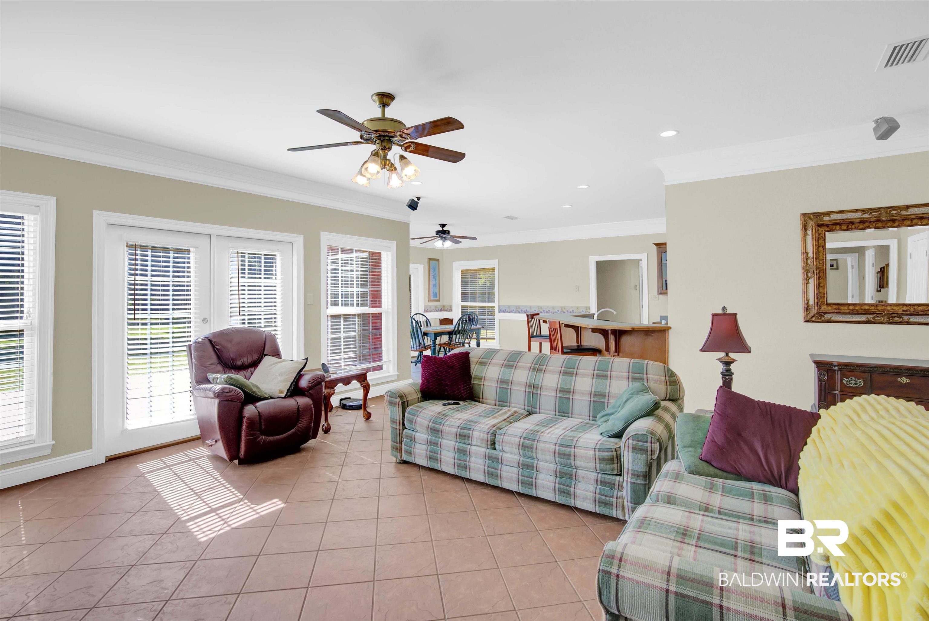 27688 Rigsby Road Daphne, AL 36526 - Photo 15 of 56 Living room with ceiling fan, crown molding, and light tile patterned floors