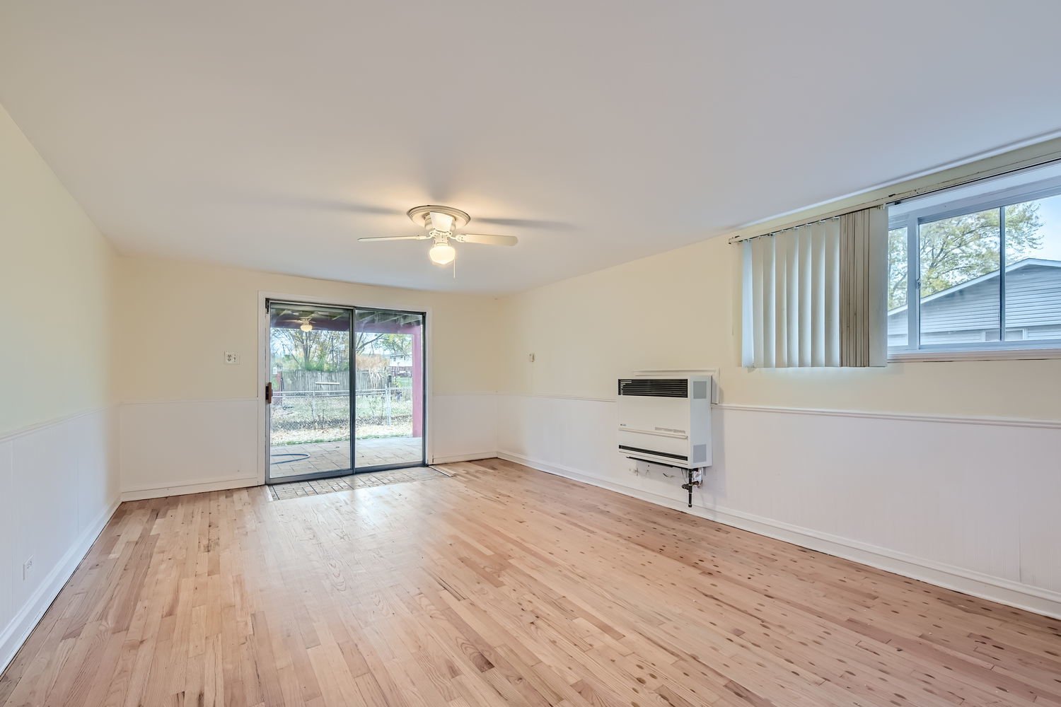 303 Audubon Road Streamwood, IL 60107 - Photo 17 of 30 a view of an empty room with a window and wooden floor