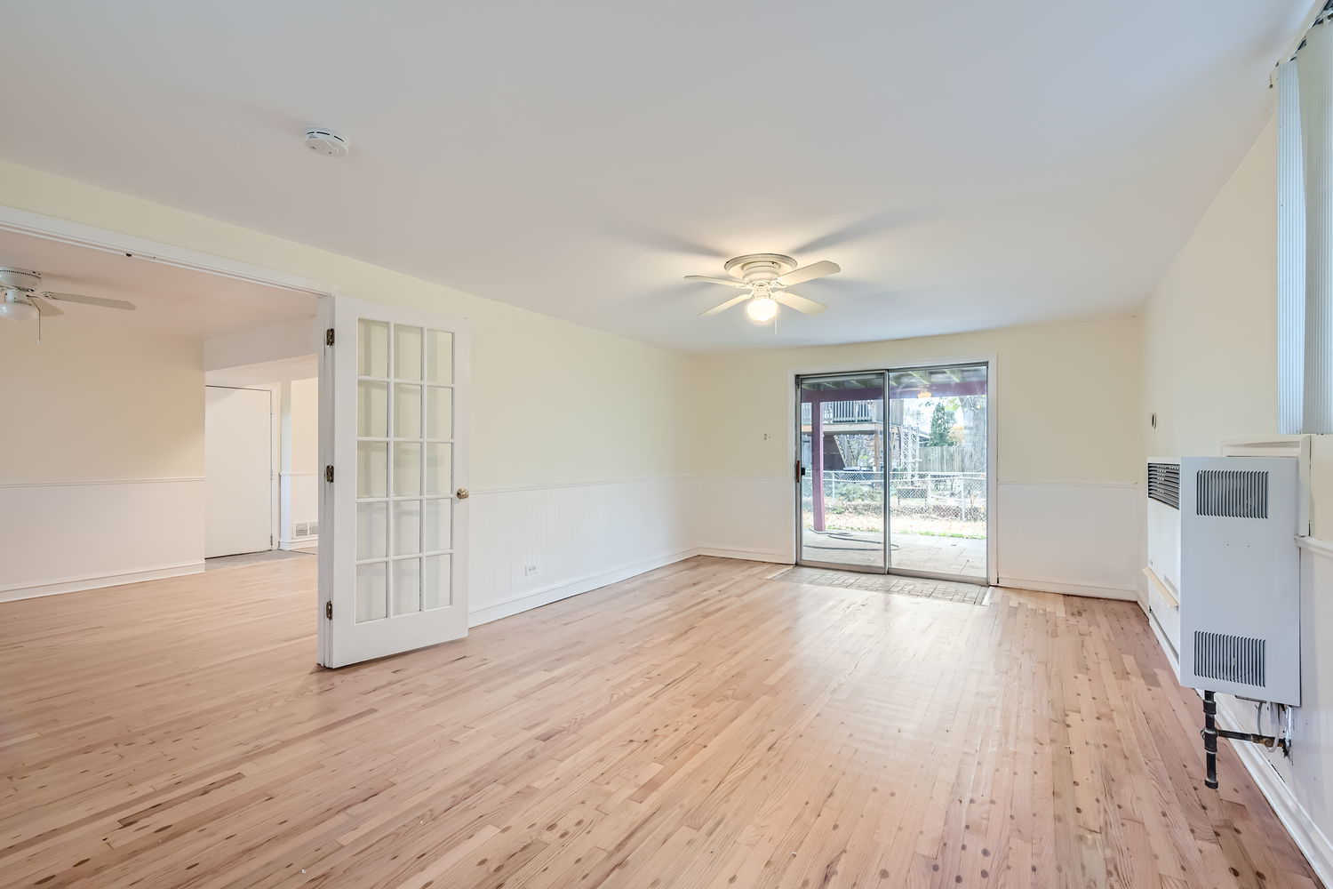 303 Audubon Road Streamwood, IL 60107 - Photo 18 of 30 a view of an empty room with wooden floor and a window
