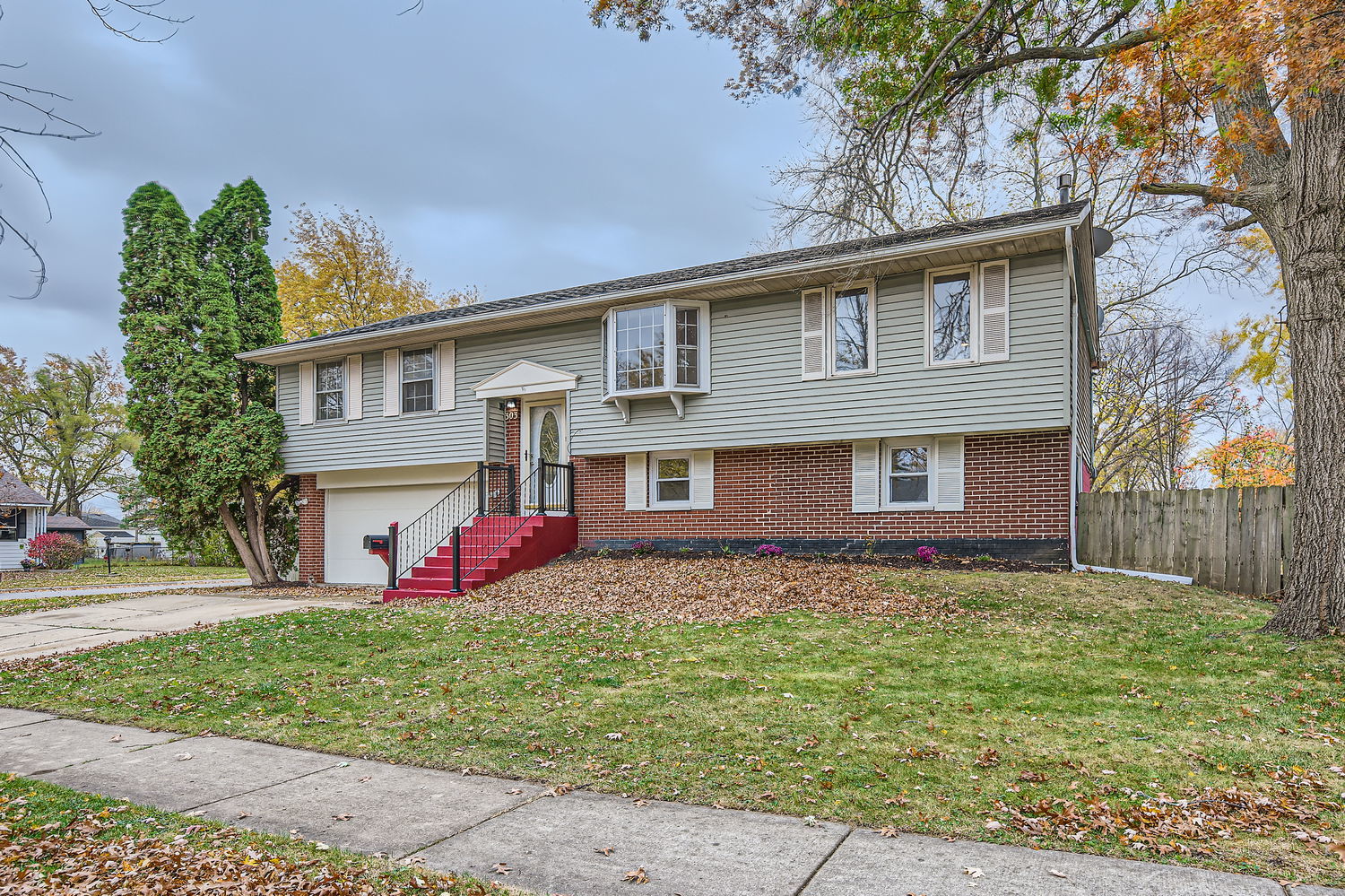 303 Audubon Road Streamwood, IL 60107 - Photo 2 of 30 a front view of a house with garden