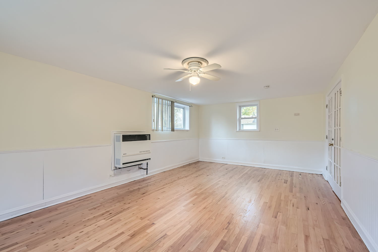 303 Audubon Road Streamwood, IL 60107 - Photo 22 of 30 an empty room with wooden floor fan and windows