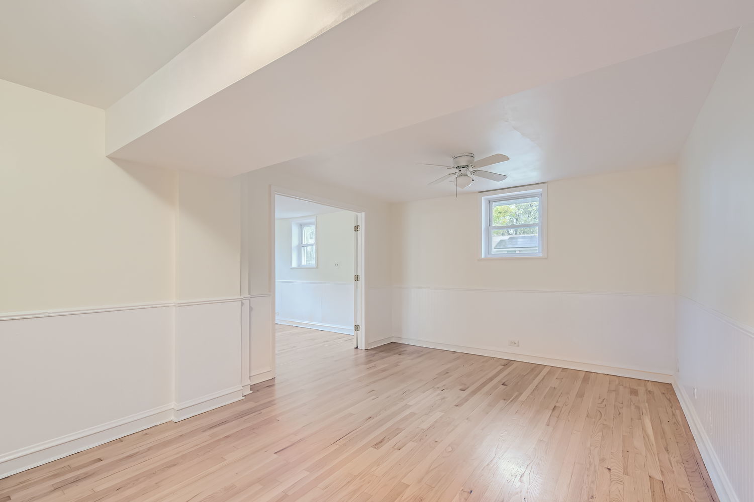 303 Audubon Road Streamwood, IL 60107 - Photo 23 of 30 an empty room with wooden floor and windows