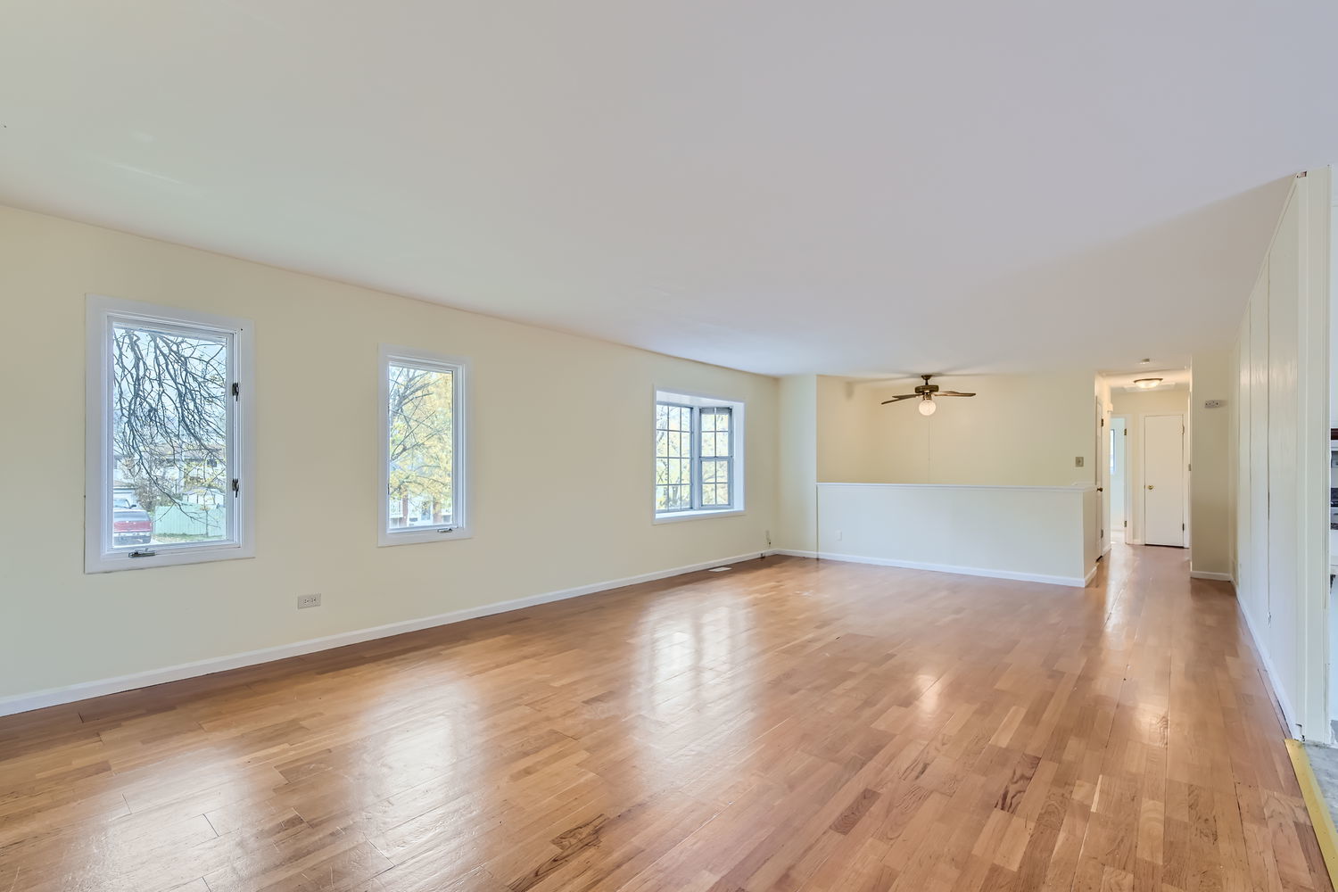 303 Audubon Road Streamwood, IL 60107 - Photo 5 of 30 a view of an empty room with wooden floor and a window