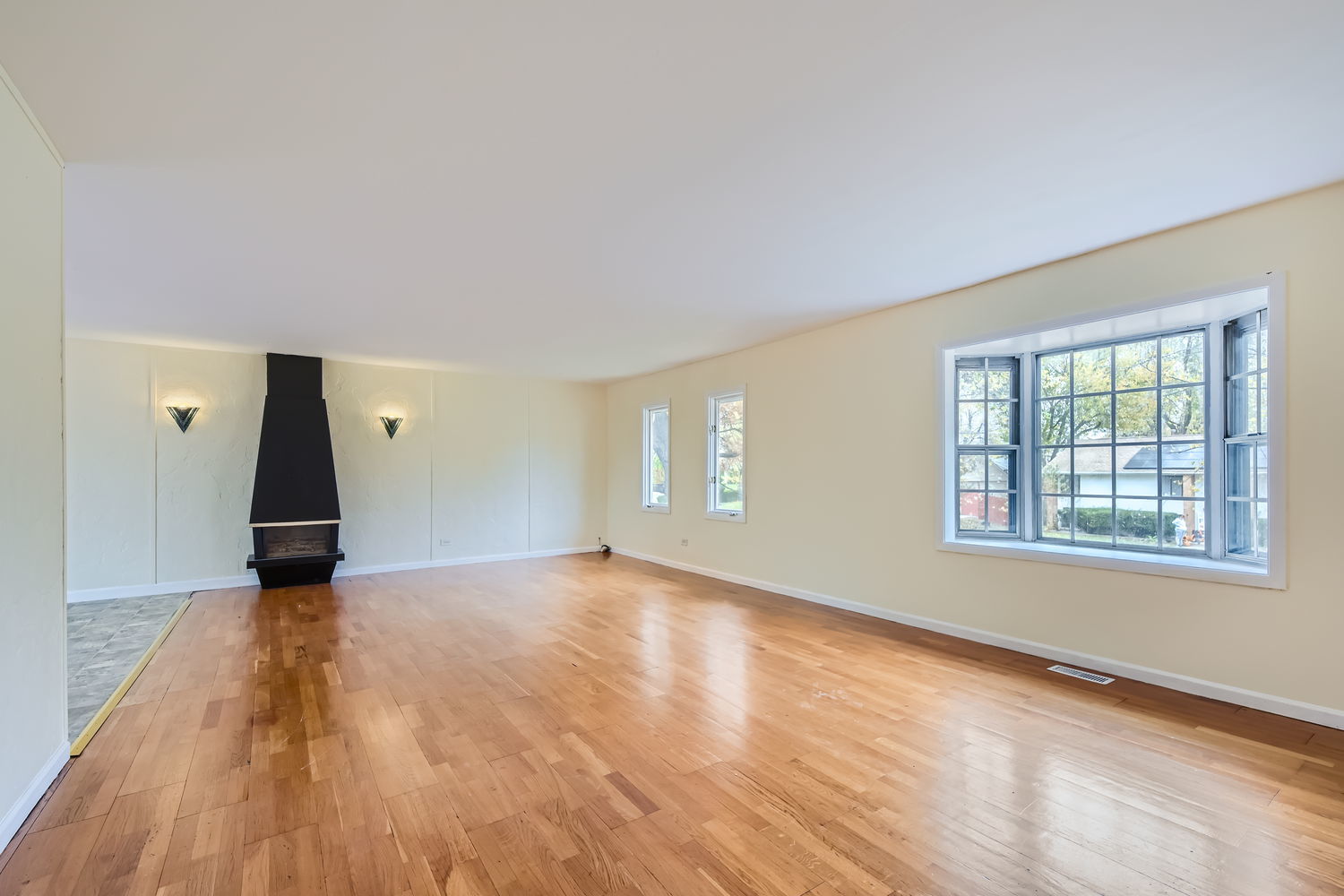 303 Audubon Road Streamwood, IL 60107 - Photo 6 of 30 a view of an empty room with wooden floor and a window
