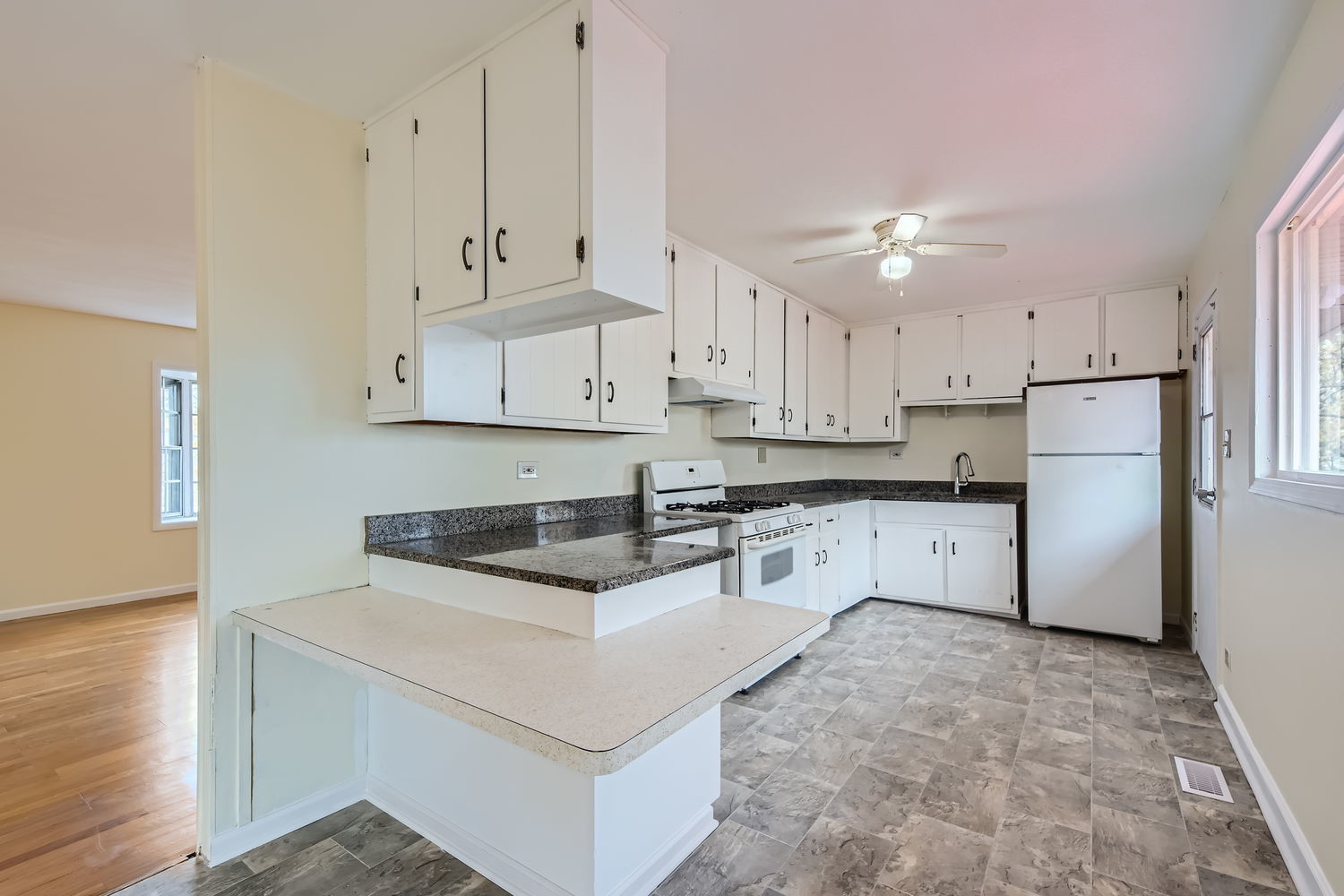 303 Audubon Road Streamwood, IL 60107 - Photo 9 of 30 a kitchen with granite countertop white cabinets and refrigerator