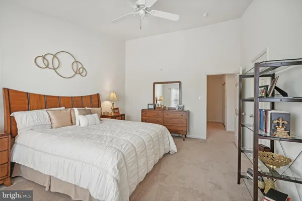 a bedroom with bed and a chandelier