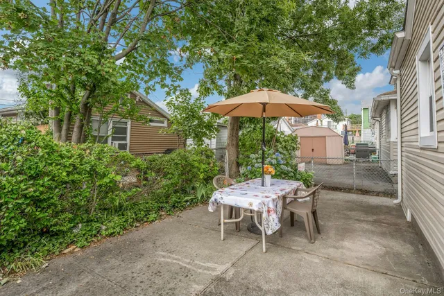 a couple of table and chairs under an umbrella