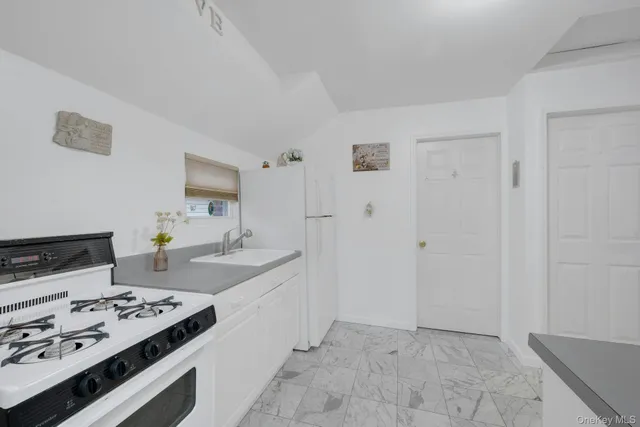 a kitchen with a stove and a refrigerator