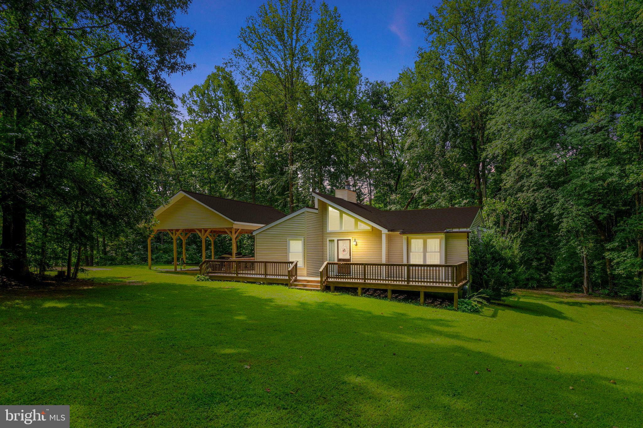 3937 Breaknock Road Bumpass, VA 23024 - Photo 3 of 94 Charming home nestled in serene greenery.