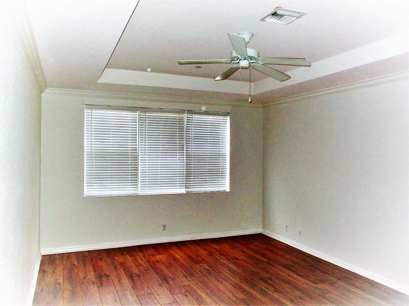 116 Lancaster Road Boynton Beach, FL 33426 - Photo 15 of 28 an empty room with a window and wooden floor