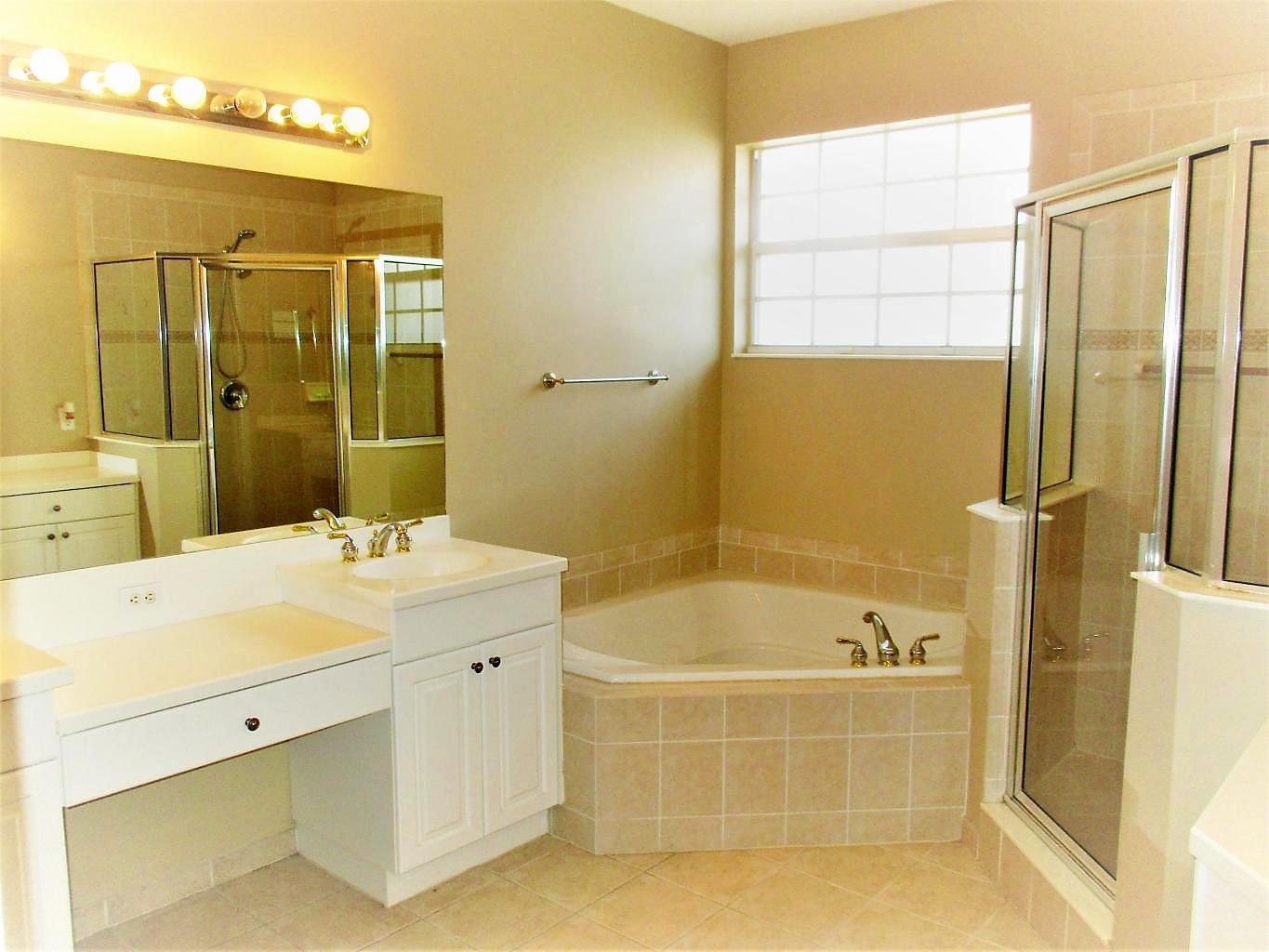 116 Lancaster Road Boynton Beach, FL 33426 - Photo 16 of 28 a bathroom with a tub sink shower and a mirror