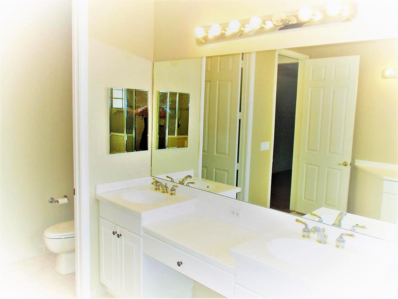 116 Lancaster Road Boynton Beach, FL 33426 - Photo 17 of 28 a bathroom with a sink and a mirror
