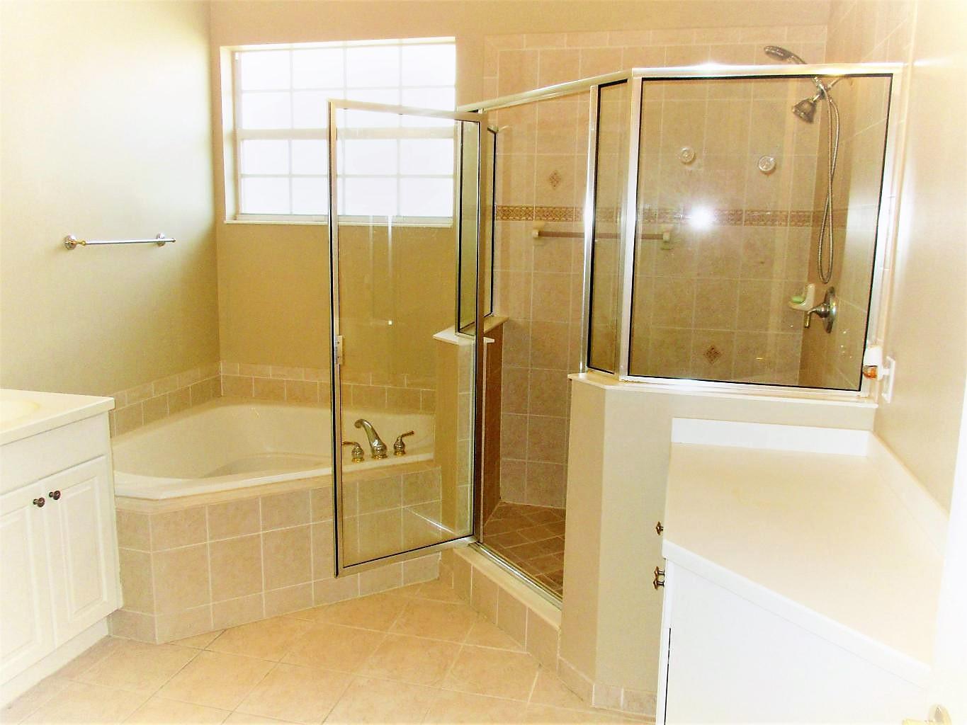 116 Lancaster Road Boynton Beach, FL 33426 - Photo 18 of 28 a bathroom with a glass shower door