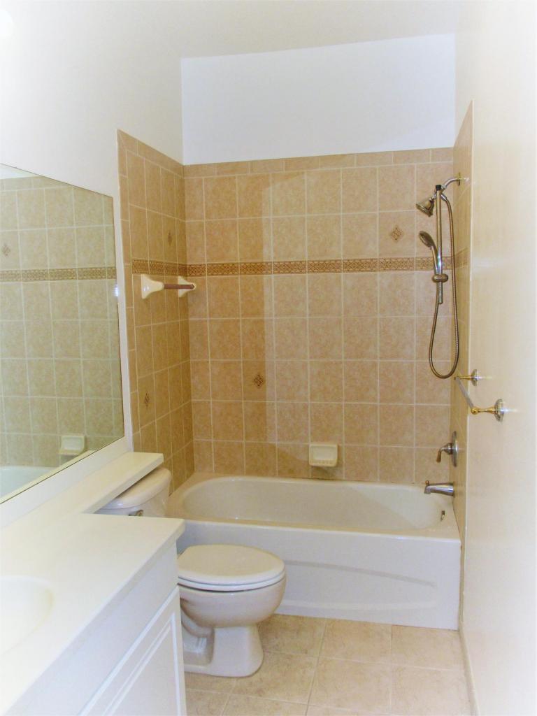 116 Lancaster Road Boynton Beach, FL 33426 - Photo 22 of 28 a bathroom with a shower a toilet and sink