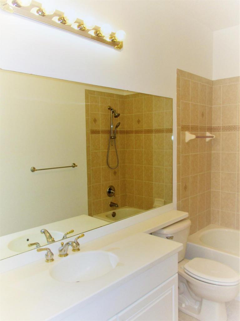 116 Lancaster Road Boynton Beach, FL 33426 - Photo 23 of 28 a bathroom with a sink mirror toilet and shower