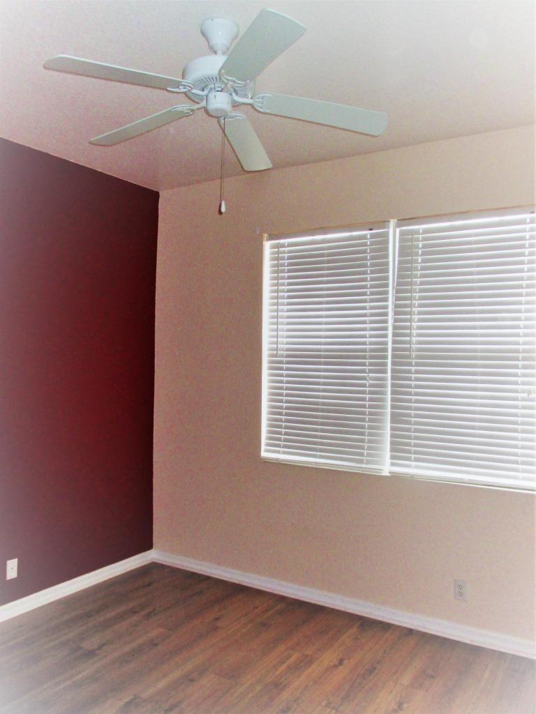 116 Lancaster Road Boynton Beach, FL 33426 - Photo 24 of 28 a view of an empty room with wooden floor and a window