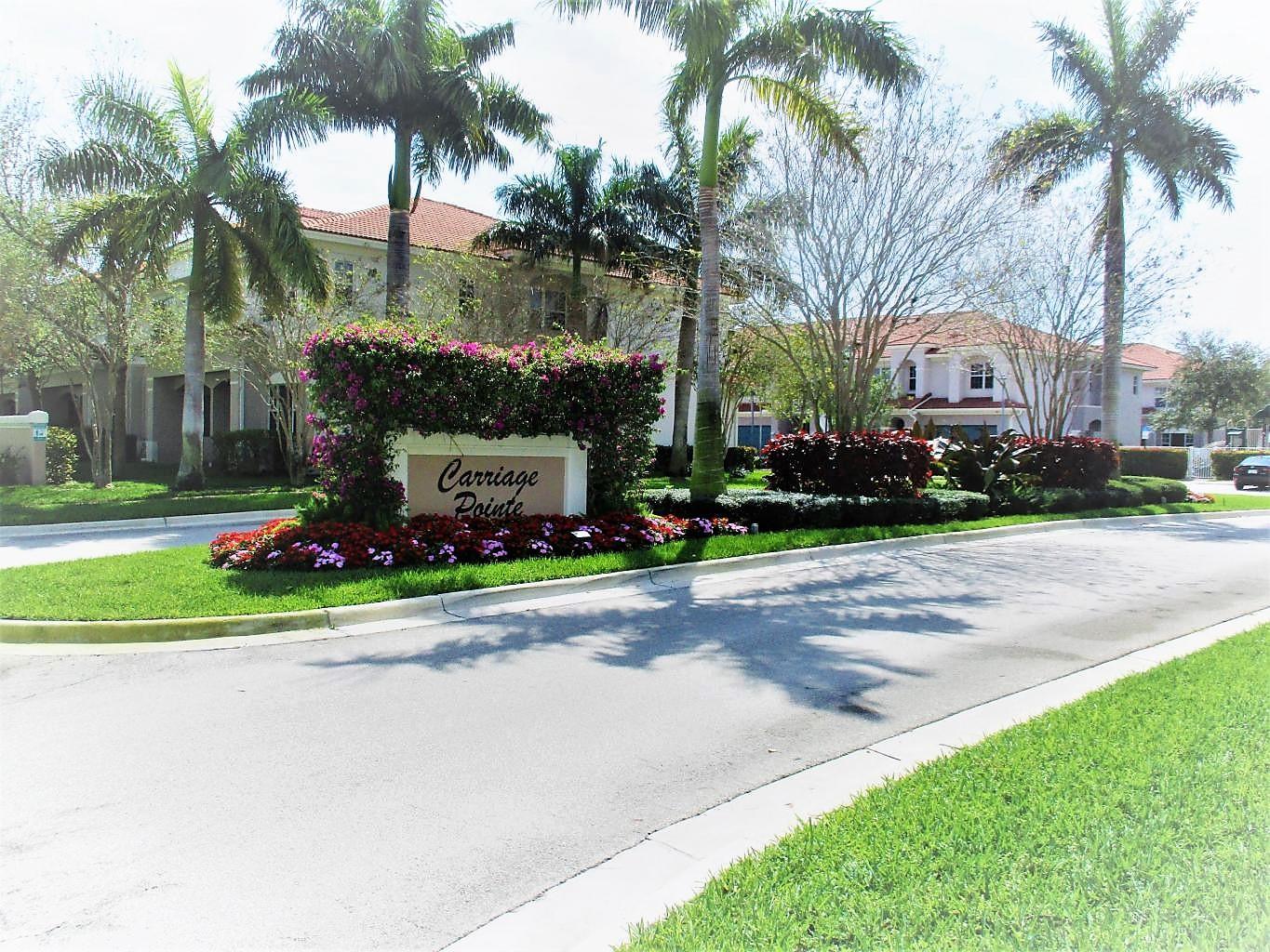 116 Lancaster Road Boynton Beach, FL 33426 - Photo 27 of 28 a front view of multi story residential apartment building with yard and green space