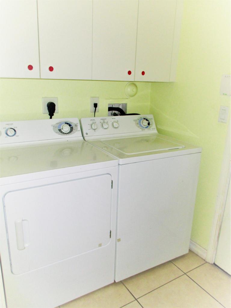 116 Lancaster Road Boynton Beach, FL 33426 - Photo 9 of 28 a utility room with a sink a washer and dryer