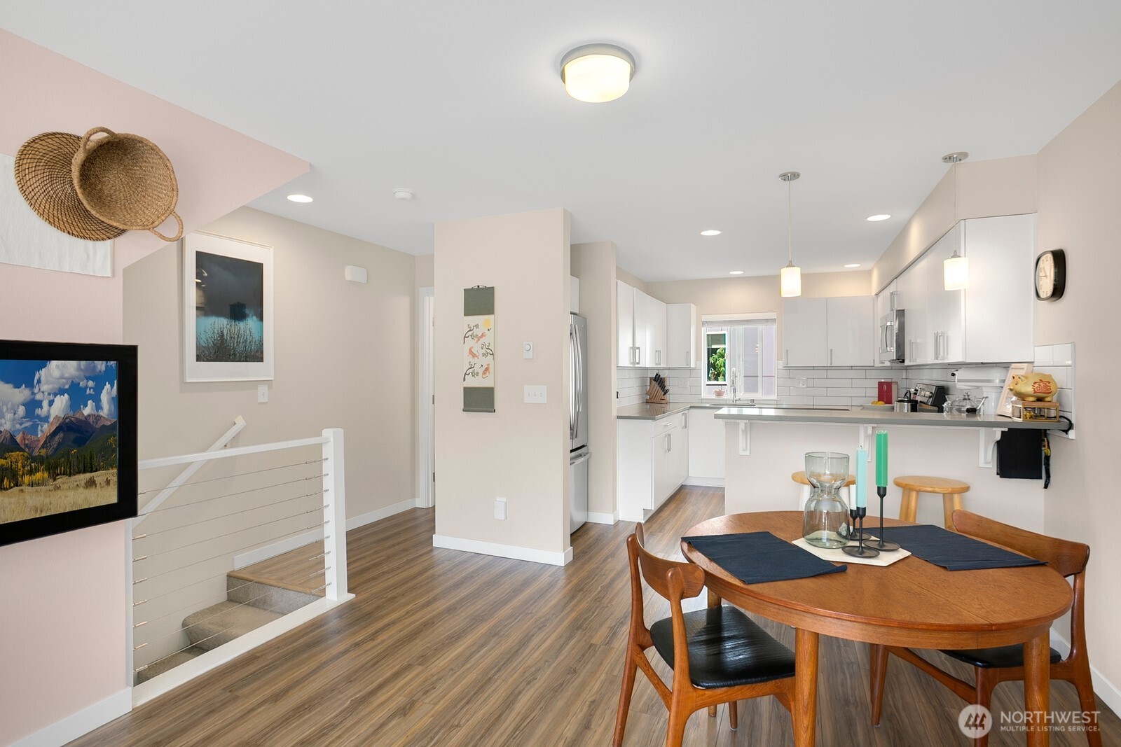 2736 South Andover Street Seattle, WA 98108 - Photo 7 of 24 a kitchen with stainless steel appliances granite countertop a stove a refrigerator a kitchen island a table and chairs with wooden floor
