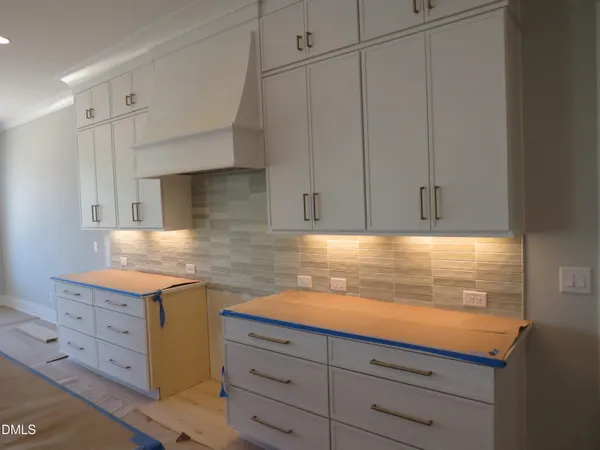 a bathroom with a granite countertop sink and a toilet