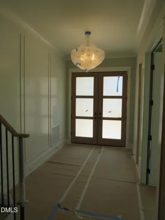 a room with stainless steel appliances kitchen island granite countertop a sink a stove and a refrigerator