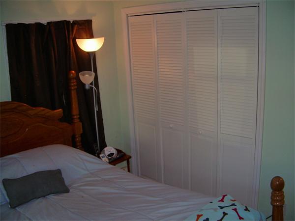 1 Anthony Road Peabody, MA 01960 - Photo 14 of 29 a bedroom with a bed and a chandelier