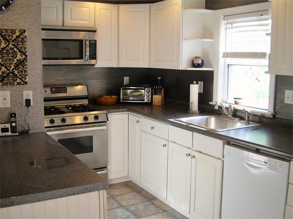 1 Anthony Road Peabody, MA 01960 - Photo 2 of 29 a kitchen with stainless steel appliances granite countertop a sink and a stove