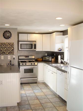 1 Anthony Road Peabody, MA 01960 - Photo 8 of 29 a kitchen with a sink a stove and cabinets