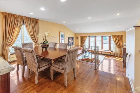a dining room with wooden floor and a table