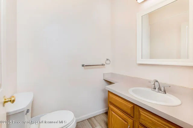 a bathroom with a sink a toilet and mirror